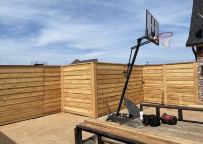 A basketball hoop in a backyard, ready for a game.