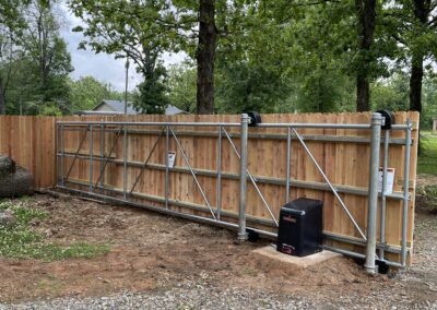 Construction of a fence in progress in front of a residential home.