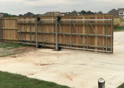 A partially open gate blocked by a fence, illustrating a mix of access and limitation.