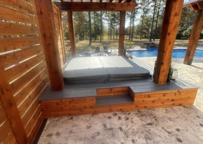 A residential property showcasing a covered patio and a spacious deck.