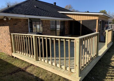 Outdoor deck with a screen and grill, perfect for summer gatherings and barbecues.