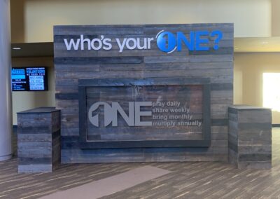 A sign displaying the words "One2One" in bold, black letters against a white background.