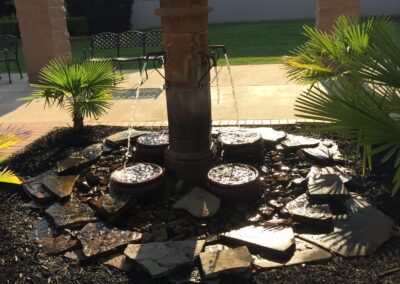 A serene courtyard fountain surrounded by lush greenery, adding a touch of tranquility to the surroundings.