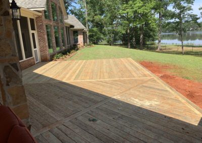 A deck setup with a screen and a grill, great for hosting outdoor parties and cooking meals.