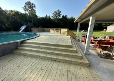 Outdoor deck with a screen and a grill, perfect for summer gatherings and barbecues.