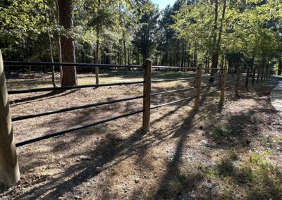 An open gate with a fence in front, symbolizing access and restriction.