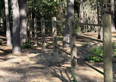 A gate left ajar, obstructed by a fence, representing a barrier and opportunity.